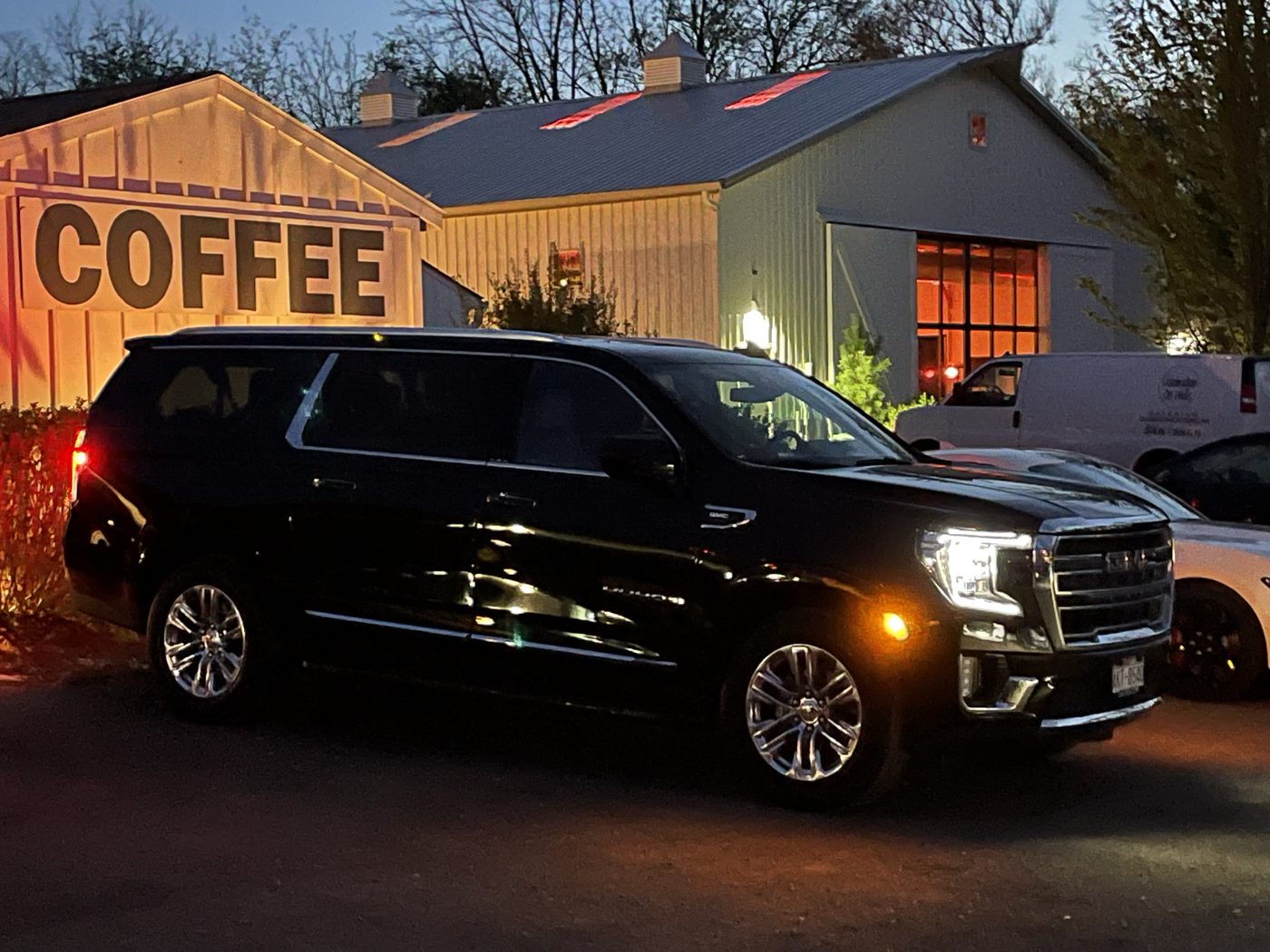 Black GMC Yukon Denali outside a Walworth County coffee house at dusk