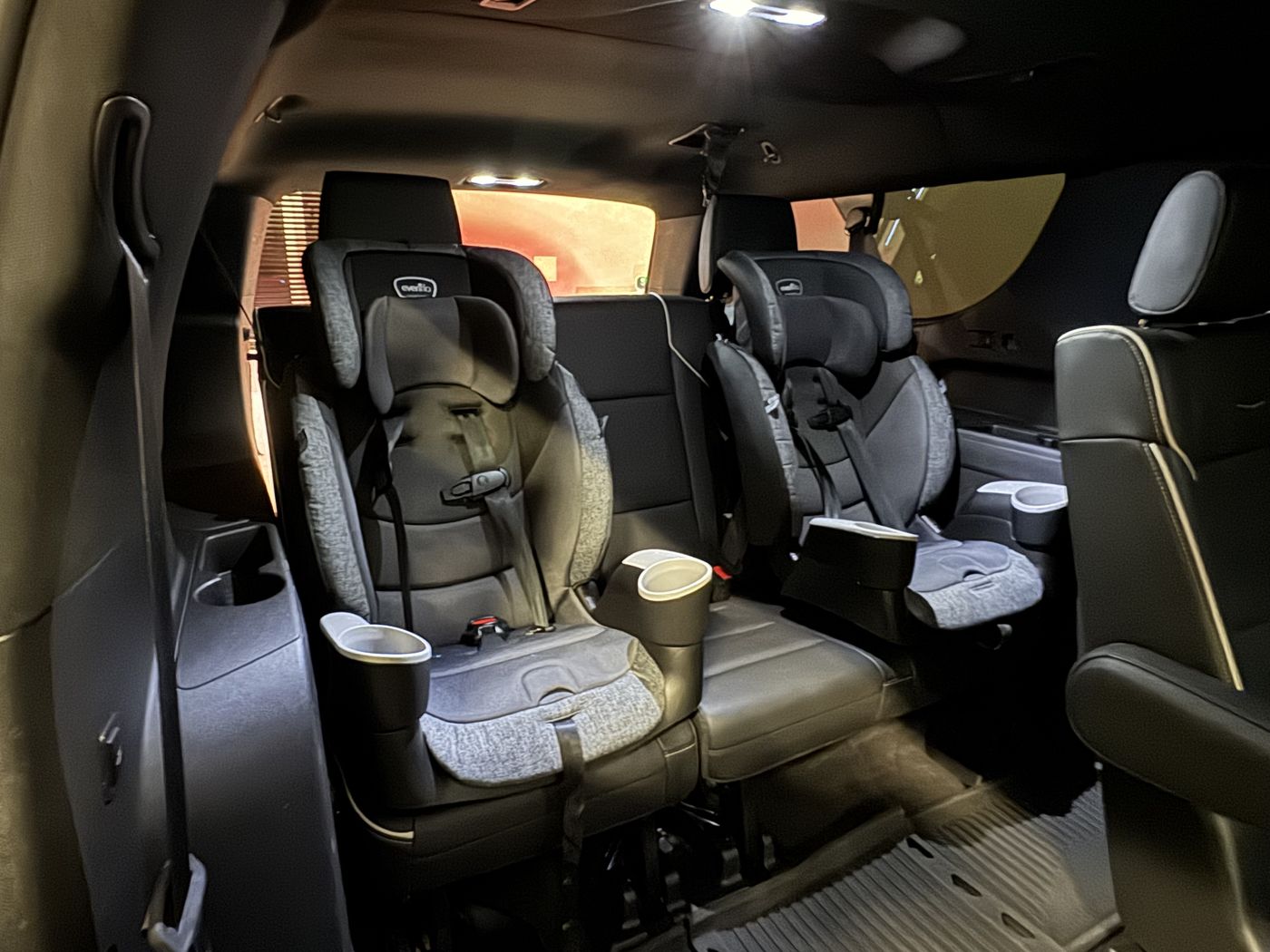 Two child seats installed in the second row of a Cadillac Escalade ESV