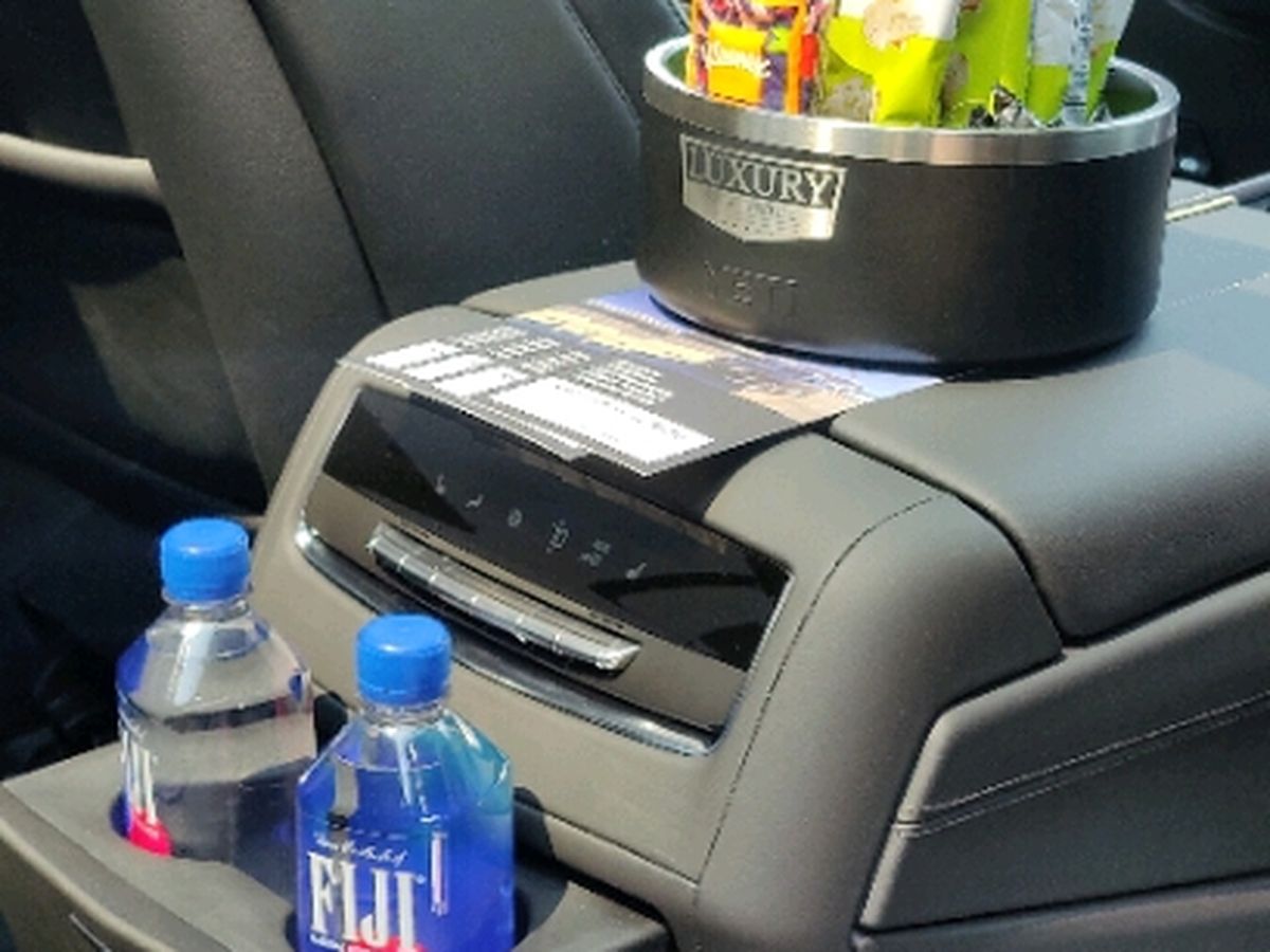 Bottled water and snacks in the rear console of a Cadillac Escalade ESV