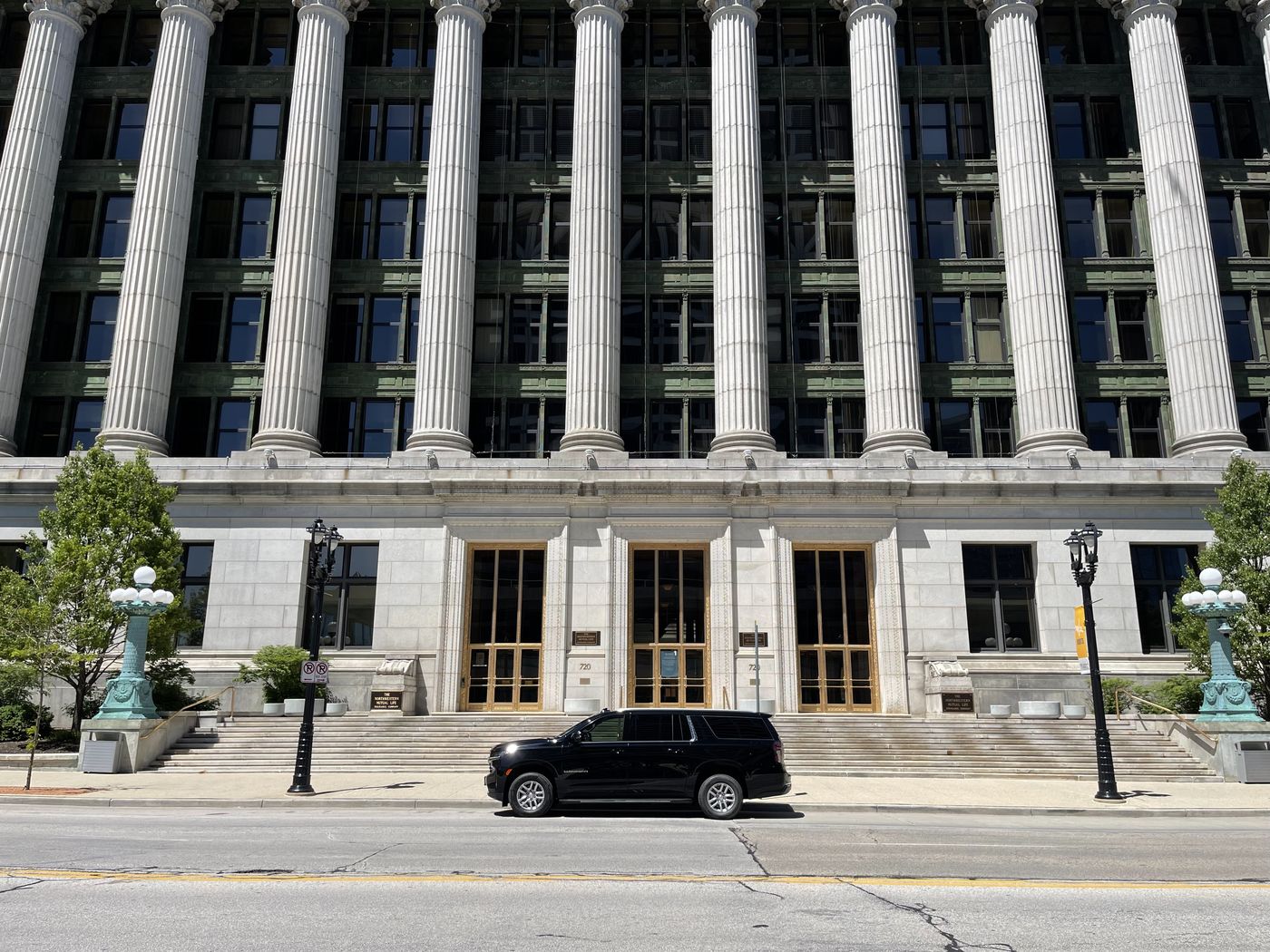 Black Chevrolet Suburban waiting at the colonnade of the Northwestern Mutual headquarters building on East Wisconsin Avenue in downtown Milwaukee