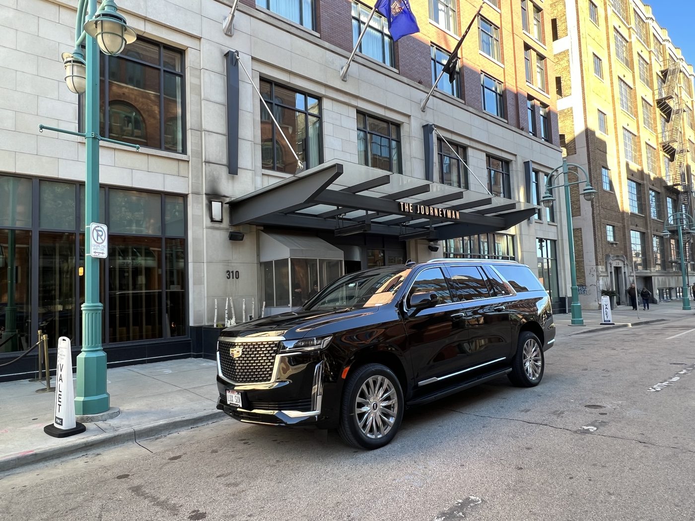 Black Cadillac Escalade ESV at the curb outside The Journeyman Hotel in the Third Ward, downtown Milwaukee