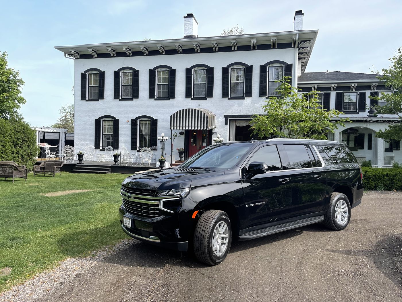 Black Chevrolet Suburban outside a historic Wisconsin wedding venue