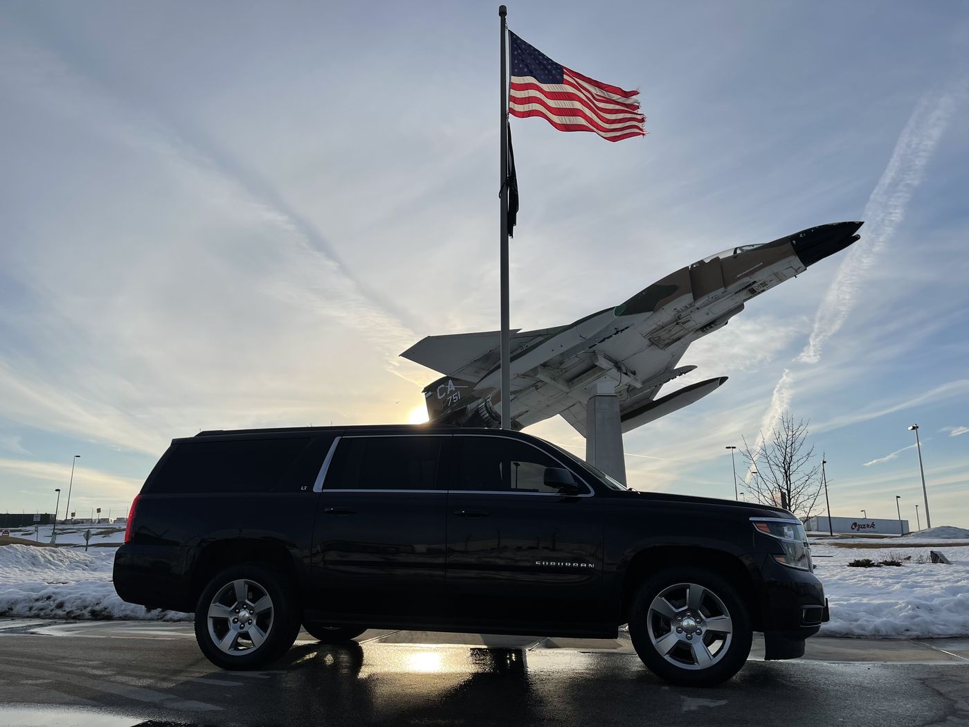 Black Chevrolet Suburban at Milwaukee Mitchell on a winter morning, the run most Cedarburg and Grafton trips start with
