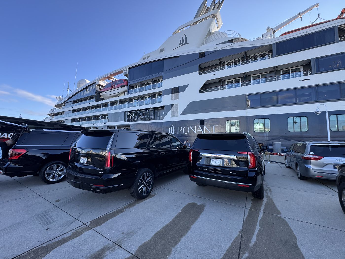 Black Cadillac Escalade ESV on the quayside at Port Milwaukee with a cruise ship alongside