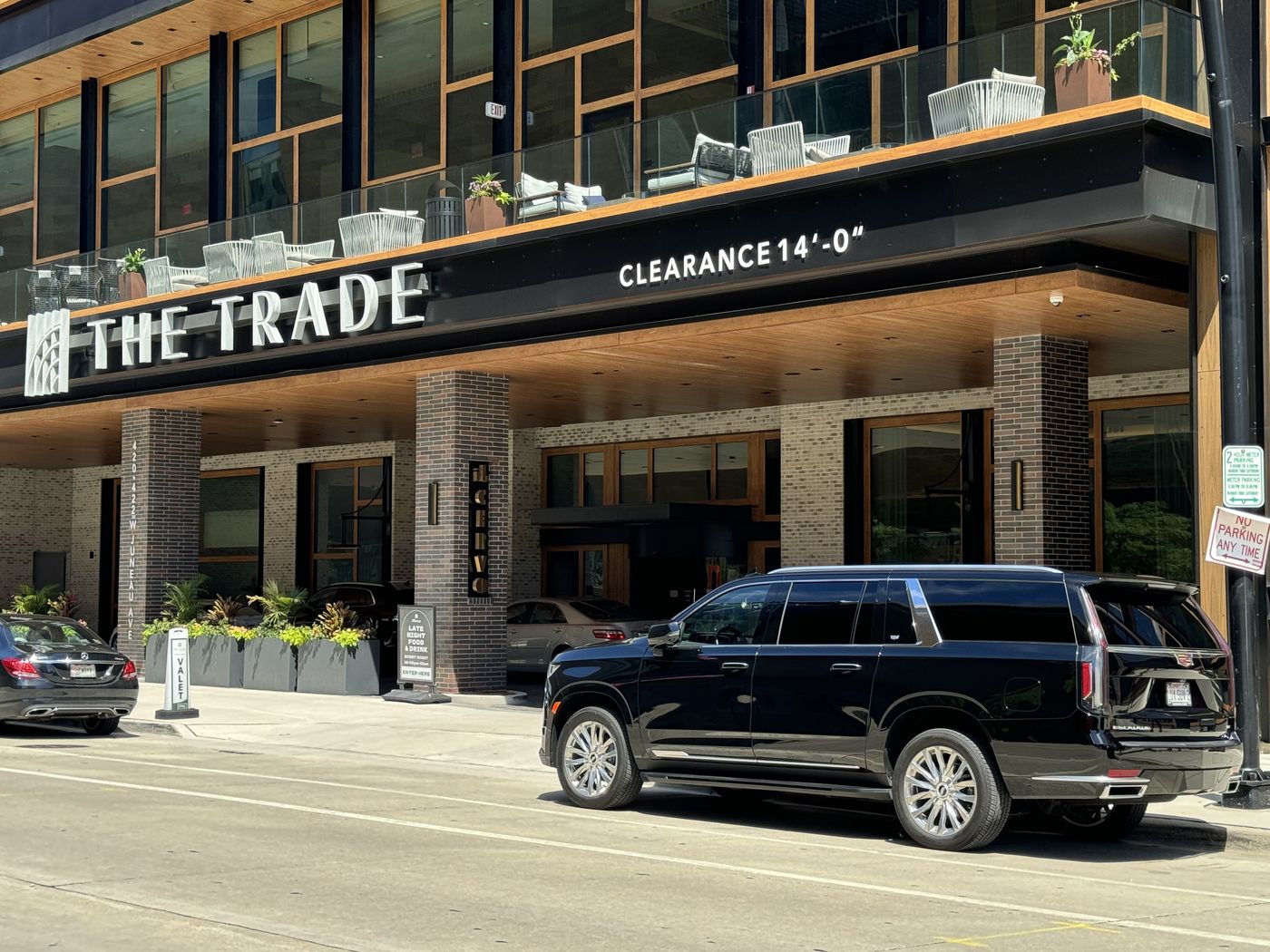 Black Chevrolet Suburban waiting outside a downtown Milwaukee hotel, where most Erin Hills groups stay