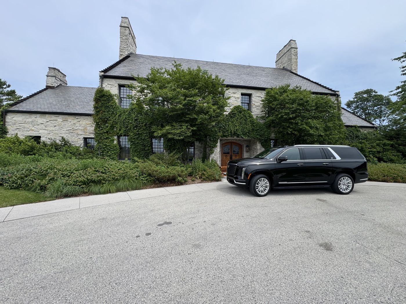 Black Cadillac Escalade ESV at the entrance to the ivy covered stone clubhouse at Whistling Straits